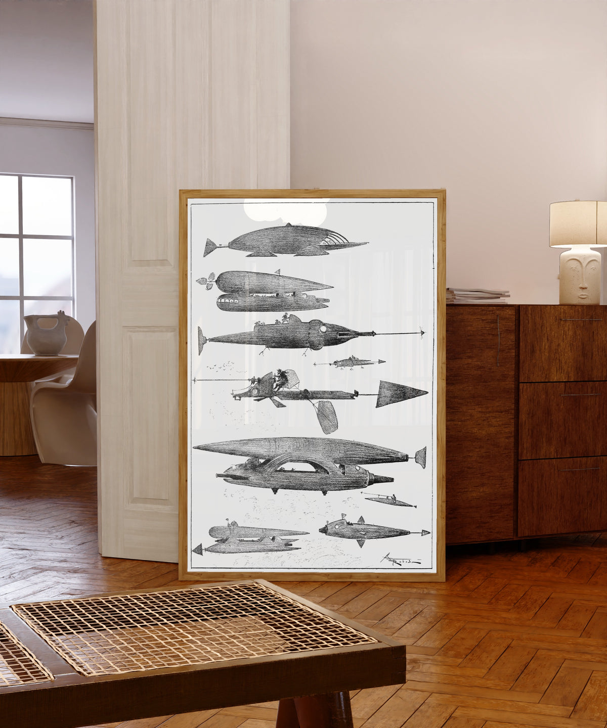 Framed art print of Quelques échantillons de la flotte aérienne by Albert Robida, in a light wood frame leaning in a warm room with a parquet floor