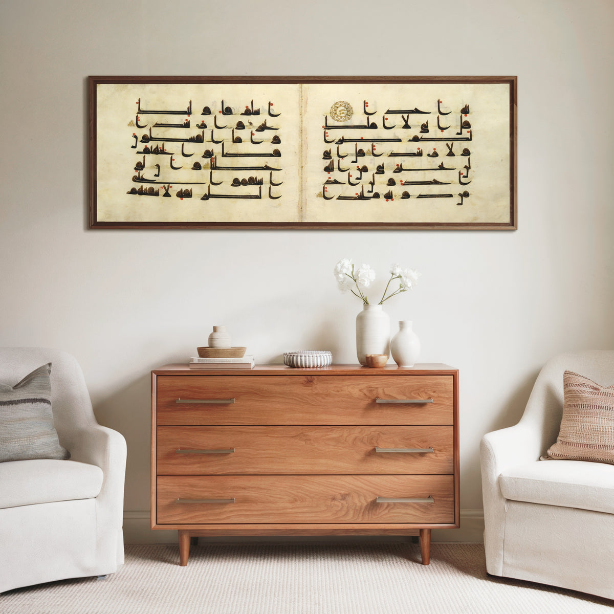 Framed art print of Qur'an Bifolium (Seven Lines on Parchment), above a wooden chest of drawers