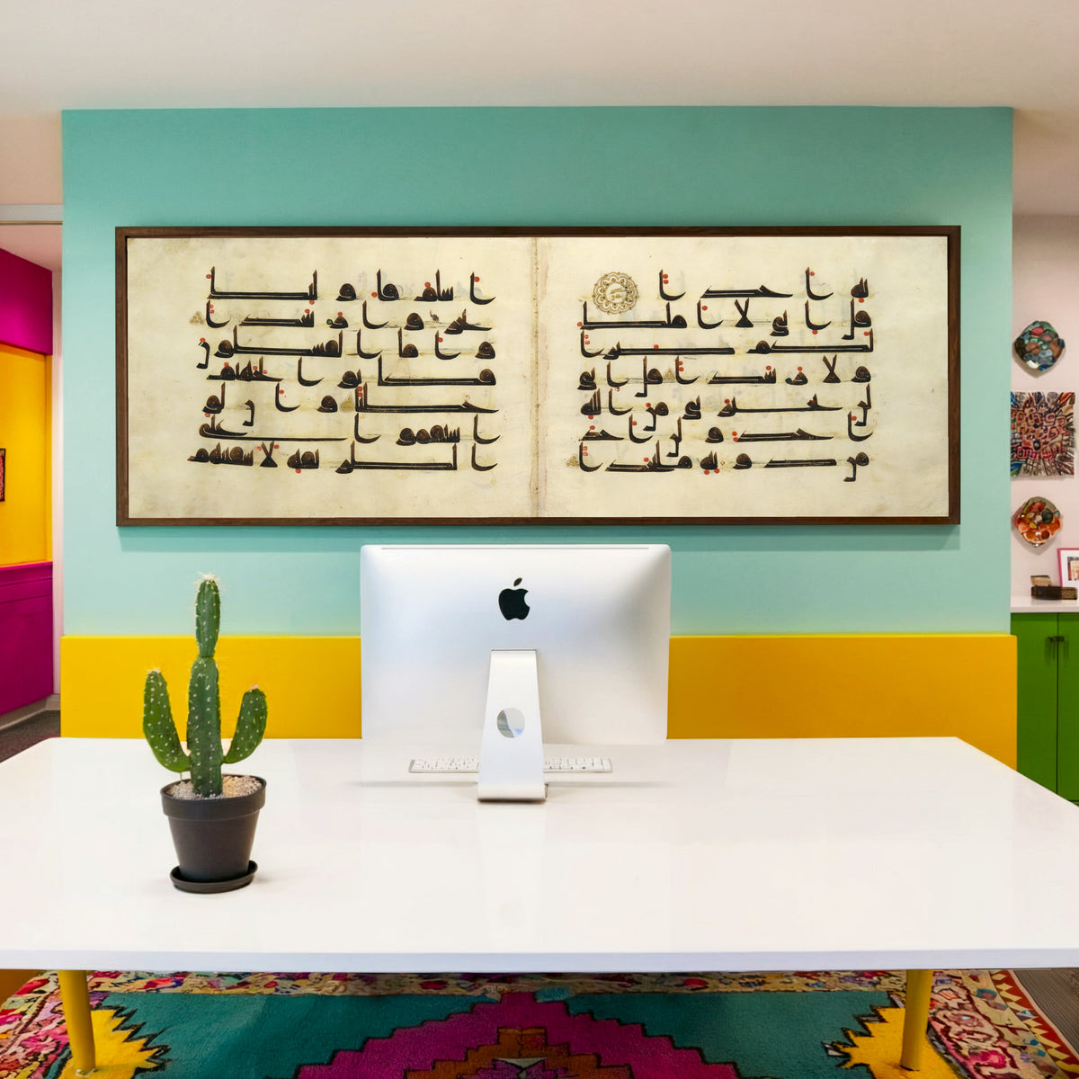Framed art print of Qur'an Bifolium (Seven Lines on Parchment), above a desk