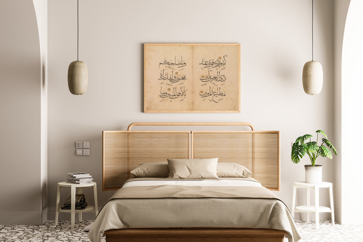 Framed art print of Qur'an Bifolium (Three Lines per Page), above a cane-headboard bed