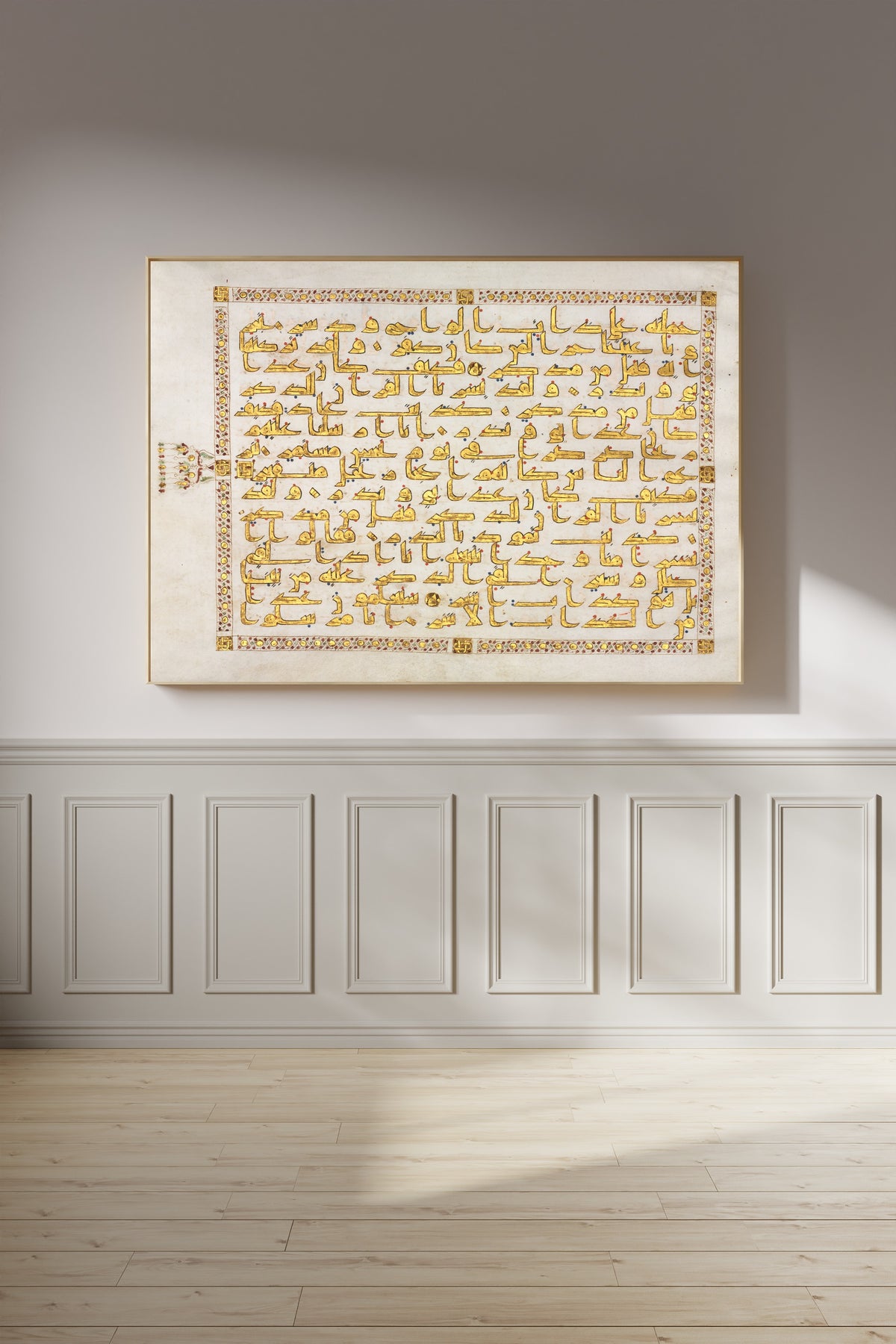 Framed art print of Qur'an Folio: Sura al-Qamar, on a panelled wall in afternoon light