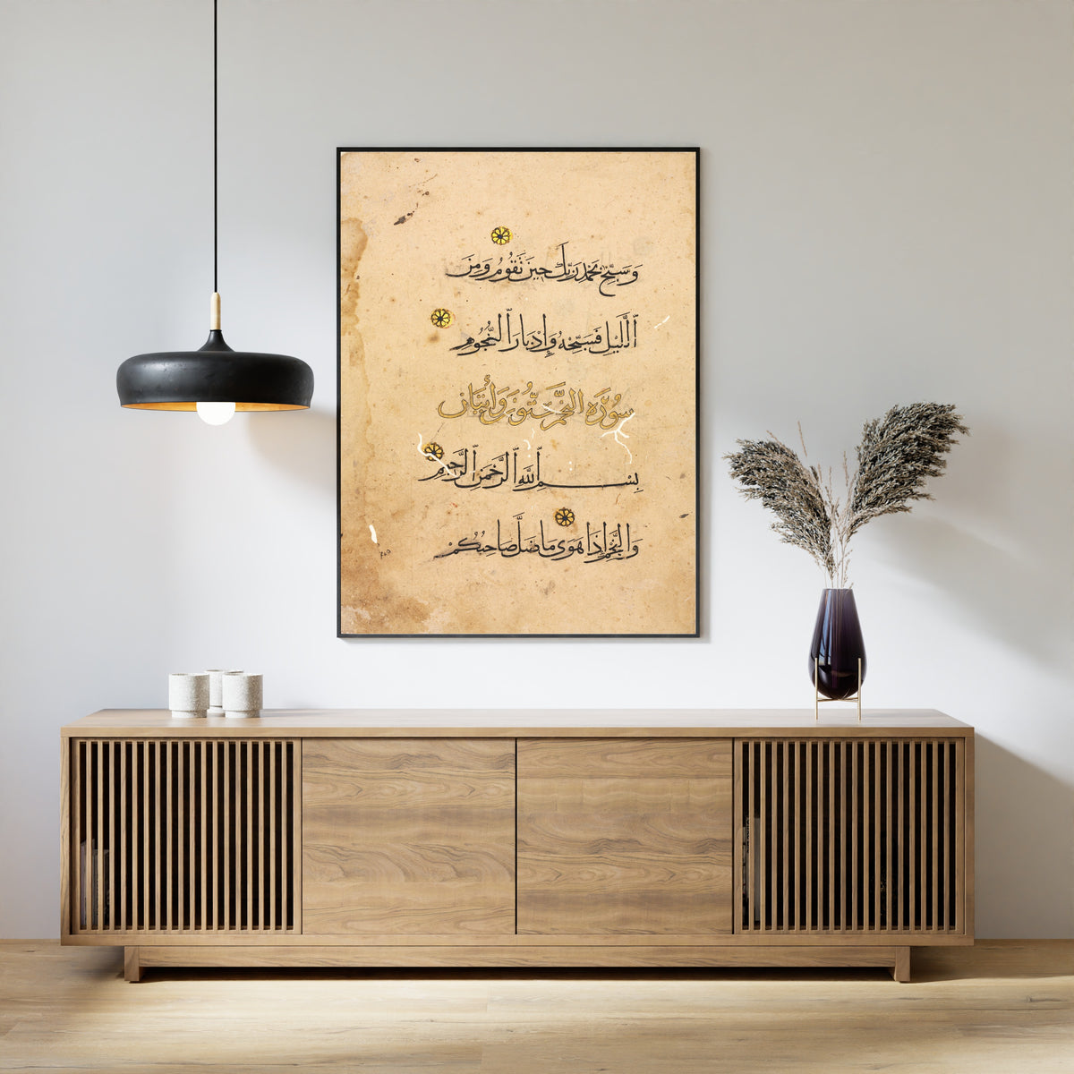 Framed art print of Qur'an Folio: Suras al-Tur and al-Najm, above a slatted wood sideboard