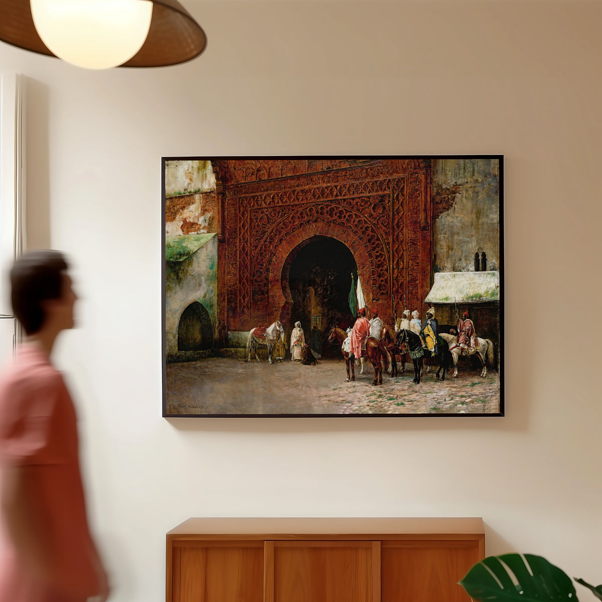 Framed art print of Rabat (The Red Gate) by Edwin Lord Weeks, in a slim black frame on a warm wall in a sunlit room