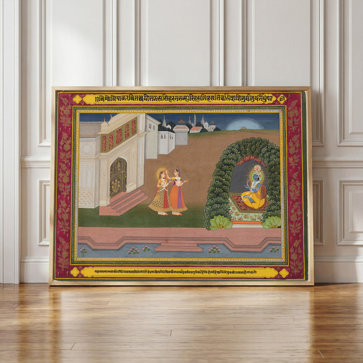 Framed art print of Radha’s Confidante Brings Her to Krishna, based on poetry of… by Jaipur school, in a light wood frame leaning against a panelled white wall