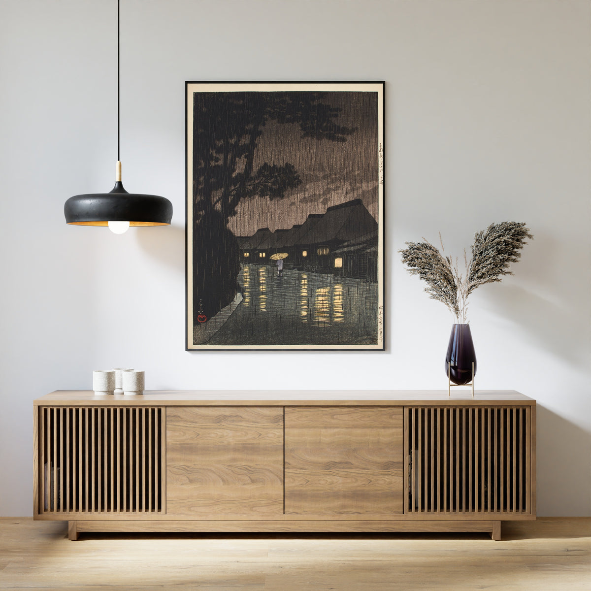 Framed art print of Rain at Maekawa, Sagami Province by Kawase Hasui, above a slatted wood sideboard