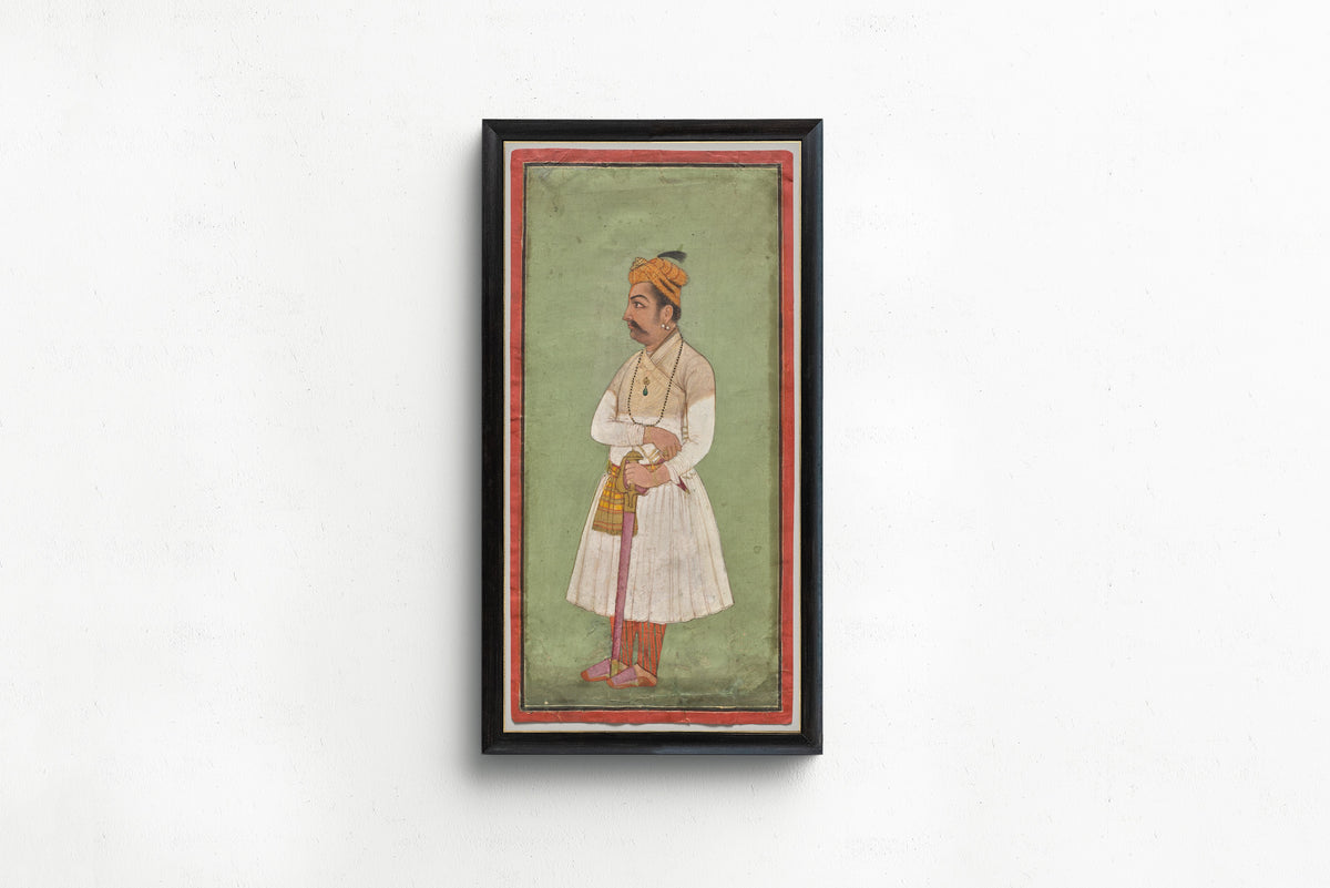 Framed art print of Raja Hari Sen of Mandi by Pahari school, in a slim black frame on a plain white wall