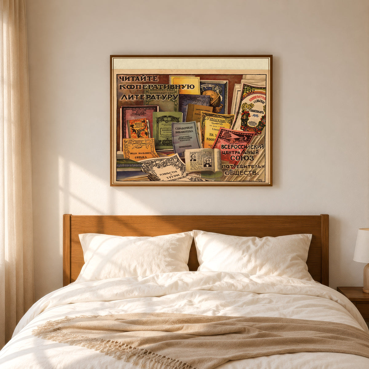 Framed art print of Read Cooperative Literature by Ignaty Nivinsky, in a slim wood frame above a bed in a sunlit bedroom