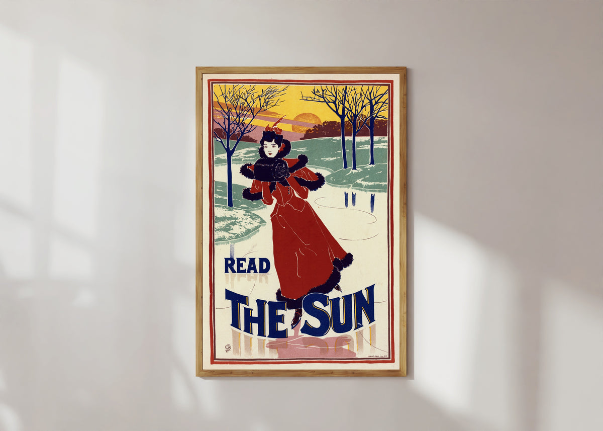 Framed art print of Read The Sun by Louis Rhead, in a light wood frame on a sunlit white wall