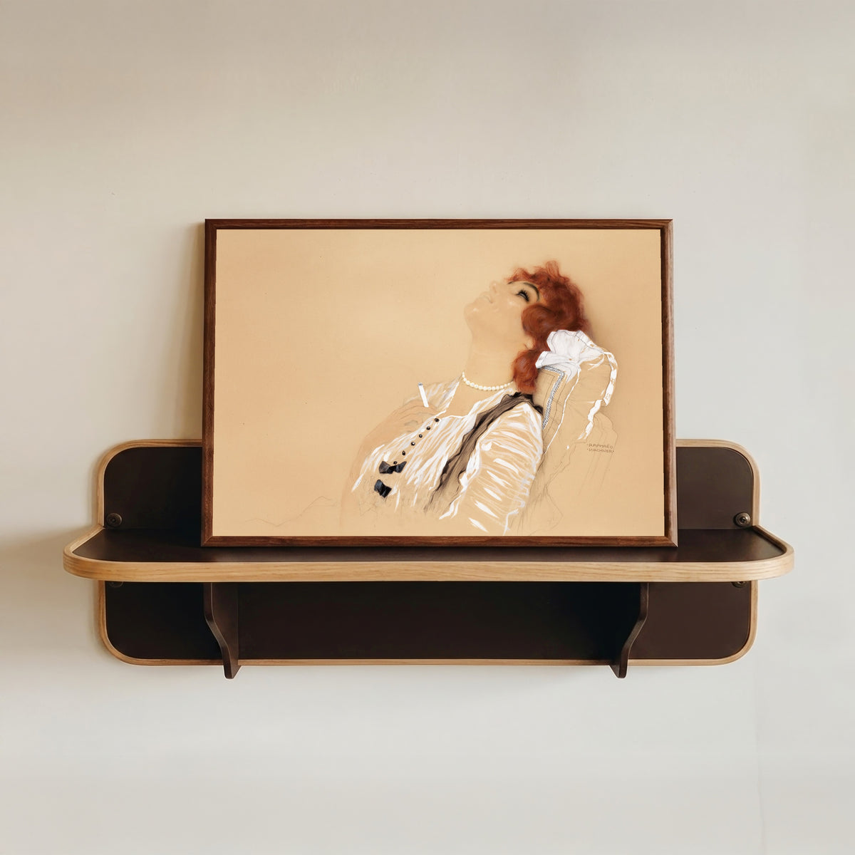 Framed art print of Redhead with a Cigarette by Raphael Kirchner, in a dark wood frame resting on a wall shelf