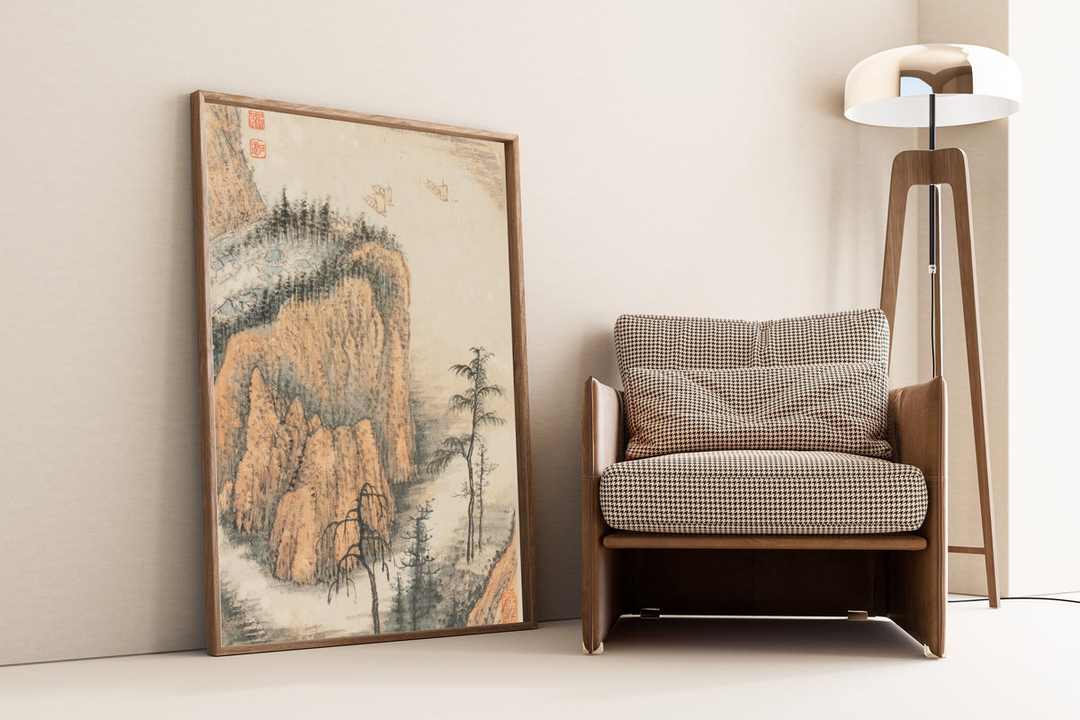 Framed art print of Reminiscences of Qinhuai River (Ochre Cliffs and Sails) by Shitao, leaning against a wall beside an armchair and a floor lamp