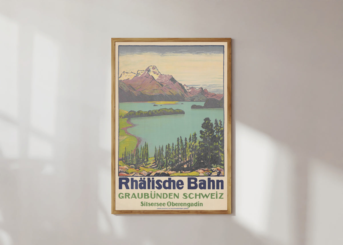 Framed art print of Rhätische Bahn: Graubünden Schweiz, Silsersee Oberengadin by Emil Cardinaux, in a light wood frame on a sunlit white wall