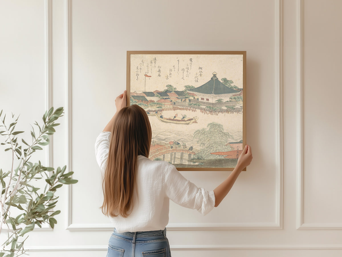 Framed art print of River Scene with Bridge in Foreground by Katsushika Hokusai, hung on a panelled wall