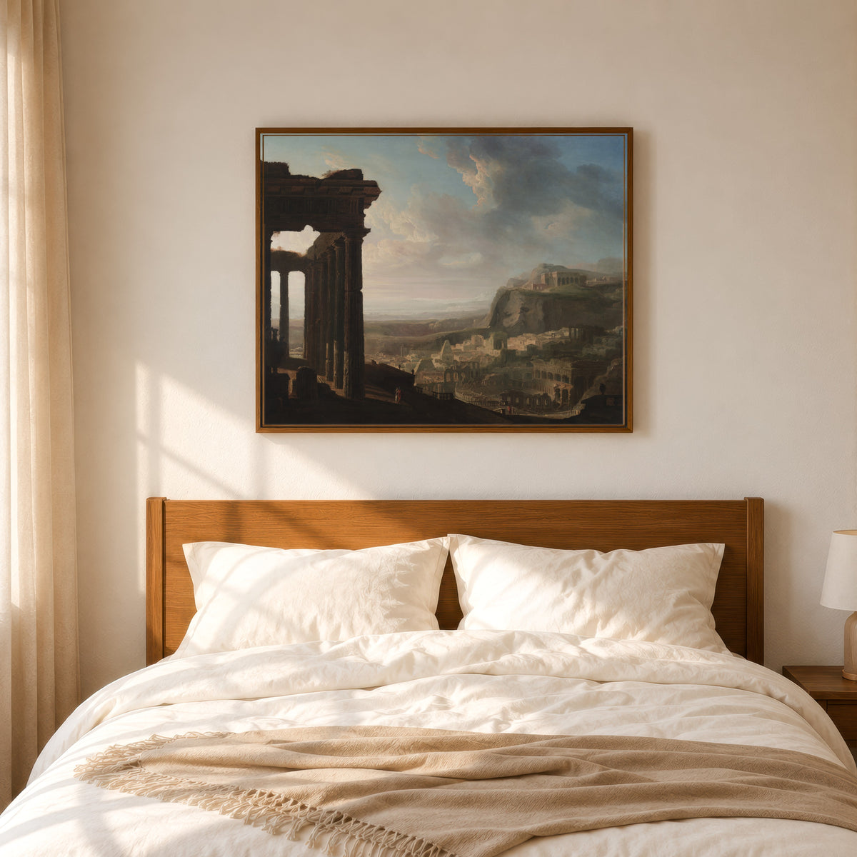 Framed art print of Ruins of an Ancient City by John Martin, in a slim wood frame above a bed in a sunlit bedroom