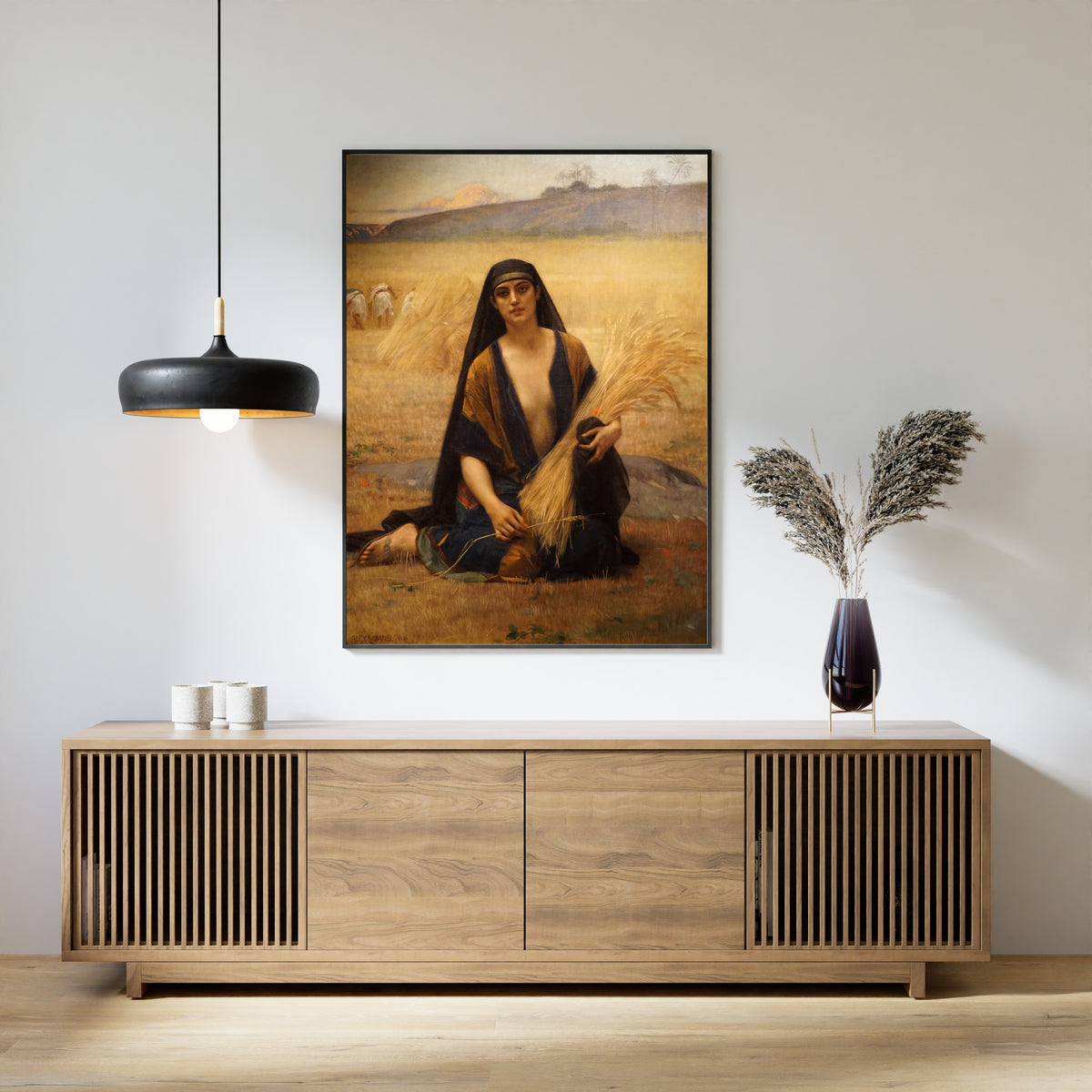 Framed art print of Ruth Gleaning in the Fields of Boaz by Alexandre Cabanel, above a slatted wood sideboard
