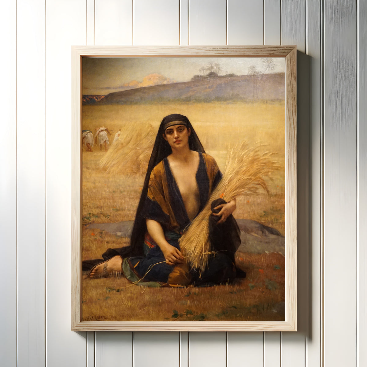 Framed art print of Ruth Gleaning in the Fields of Boaz by Alexandre Cabanel, in a light wood frame on a white panelled wall