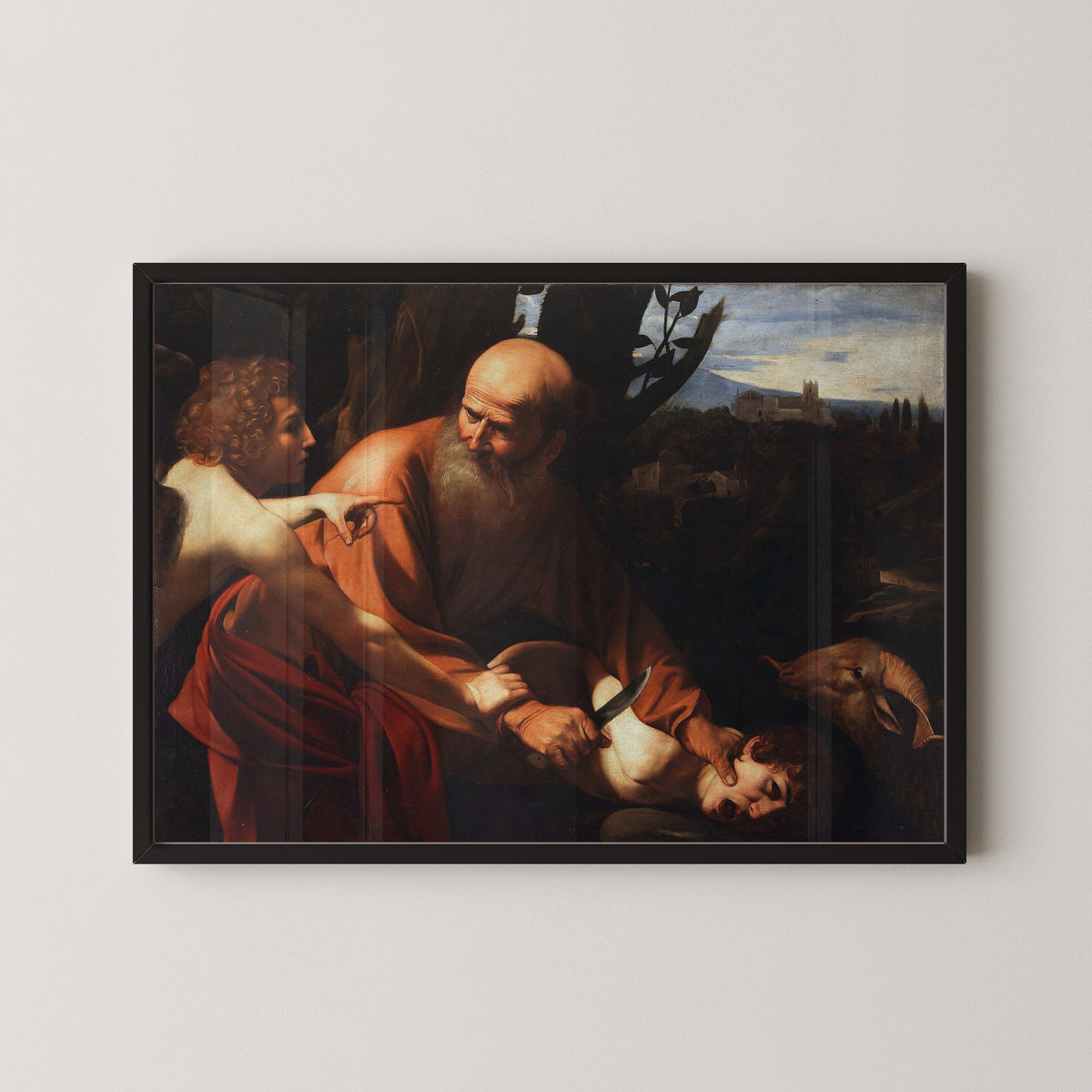 Framed art print of Sacrifice of Isaac by Caravaggio, in a black frame on a pale wall