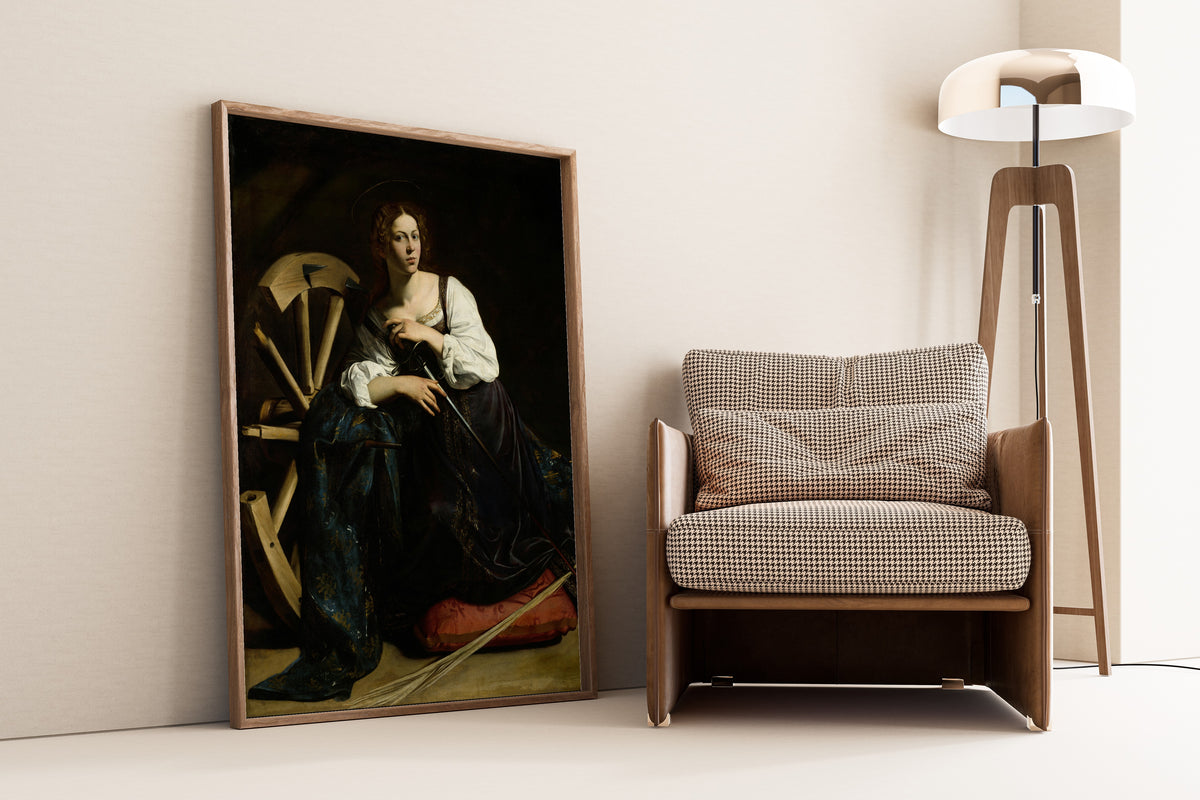 Framed art print of Saint Catherine of Alexandria by Caravaggio, leaning against a wall beside an armchair and a floor lamp