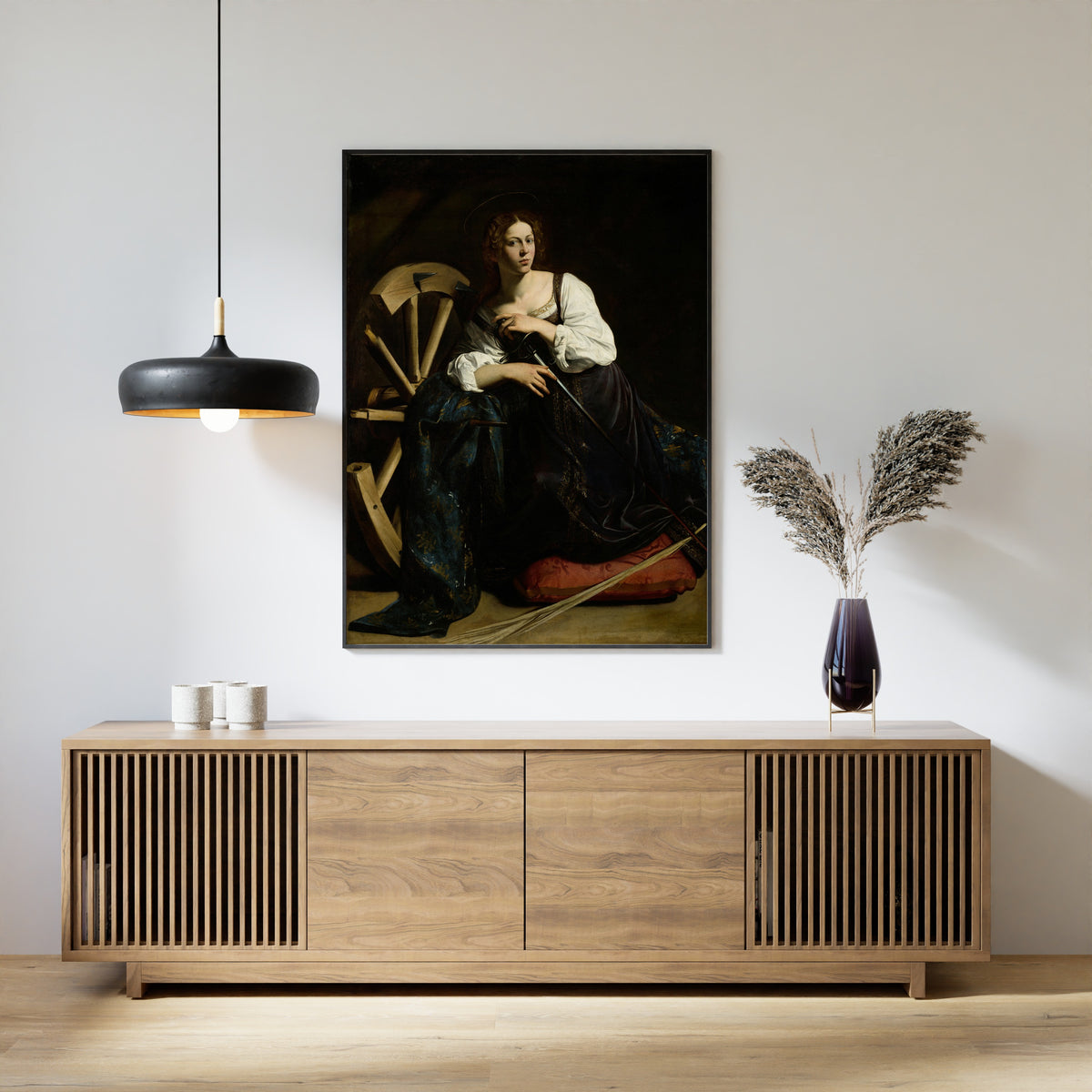 Framed art print of Saint Catherine of Alexandria by Caravaggio, above a slatted wood sideboard