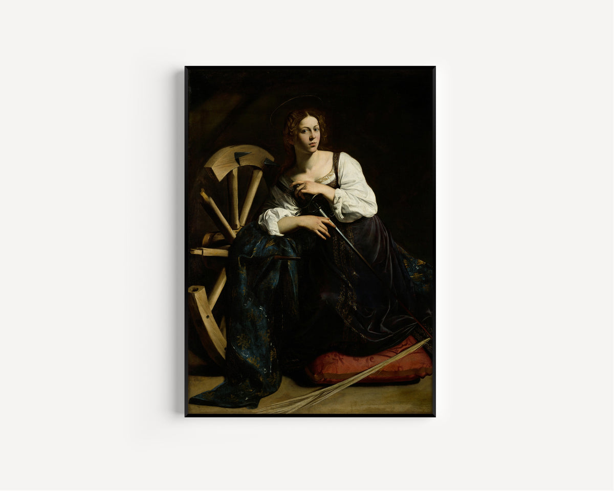 Framed art print of Saint Catherine of Alexandria by Caravaggio, in a slim black frame on a plain white wall