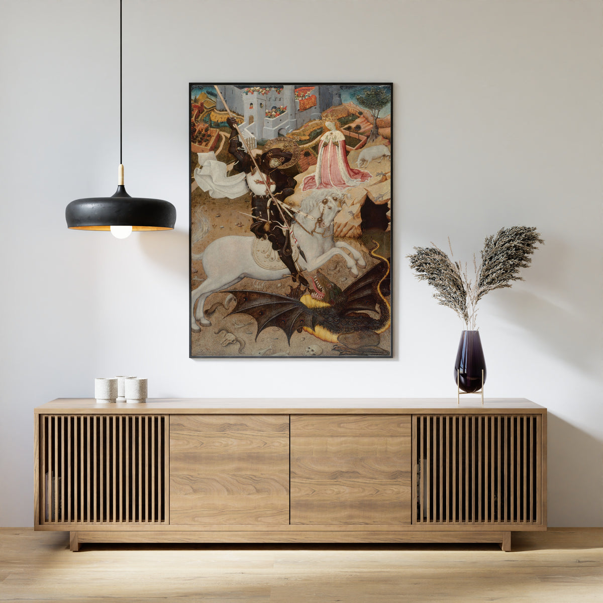 Framed art print of Saint George and the Dragon by Bernat Martorell, above a slatted wood sideboard