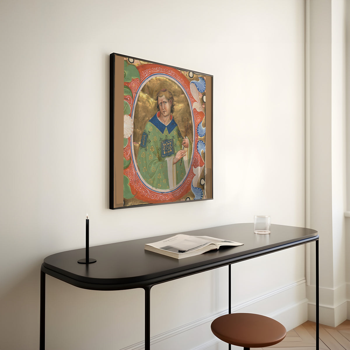 Framed art print of Saint Lawrence by Master of the Murano Gradual, above a slim black console table