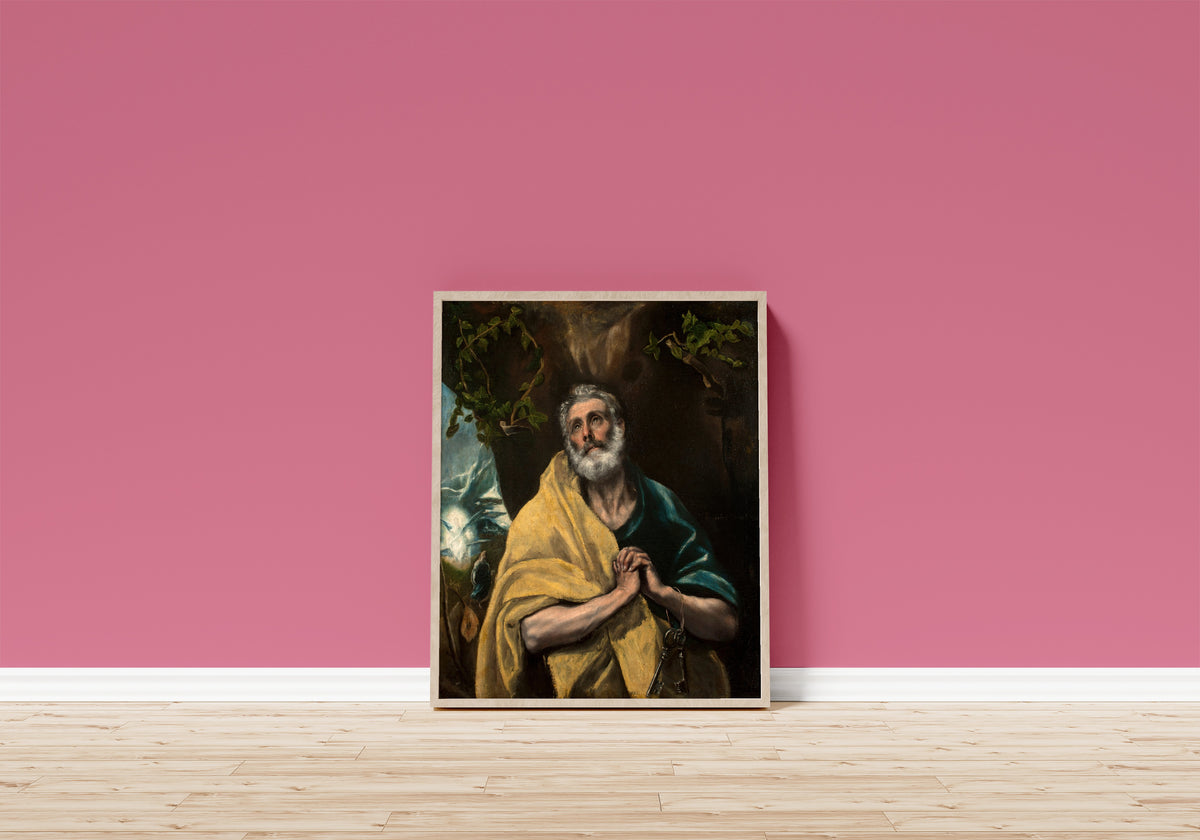 Framed art print of Saint Peter in Tears by El Greco, in a light wood frame leaning on a pink wall above a wooden floor