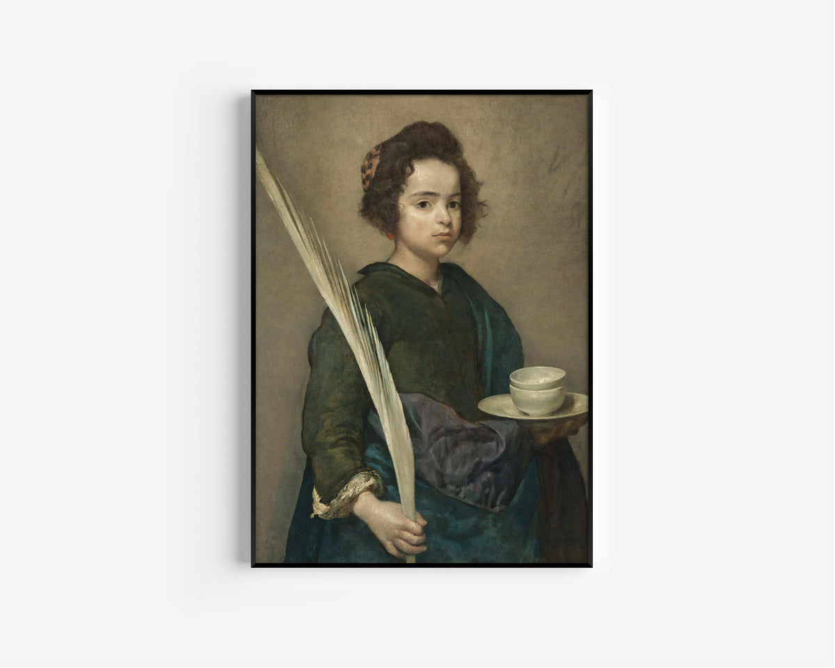 Framed art print of Saint Rufina by Diego Velázquez, in a slim black frame on a plain white wall