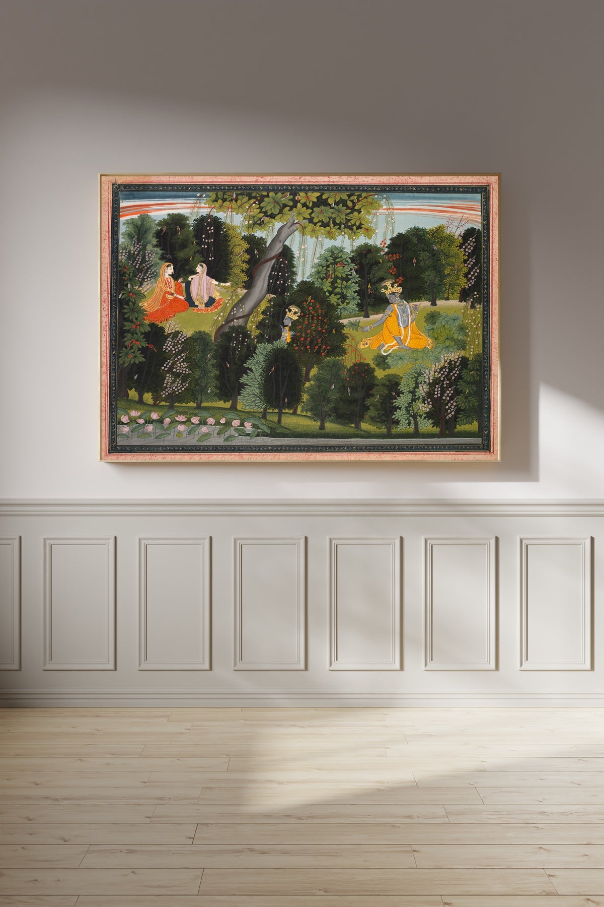 Framed art print of Sakhi Persuades Radha to Meet Krishna, from a Gita Govinda by Purkhu, on a panelled wall in afternoon light