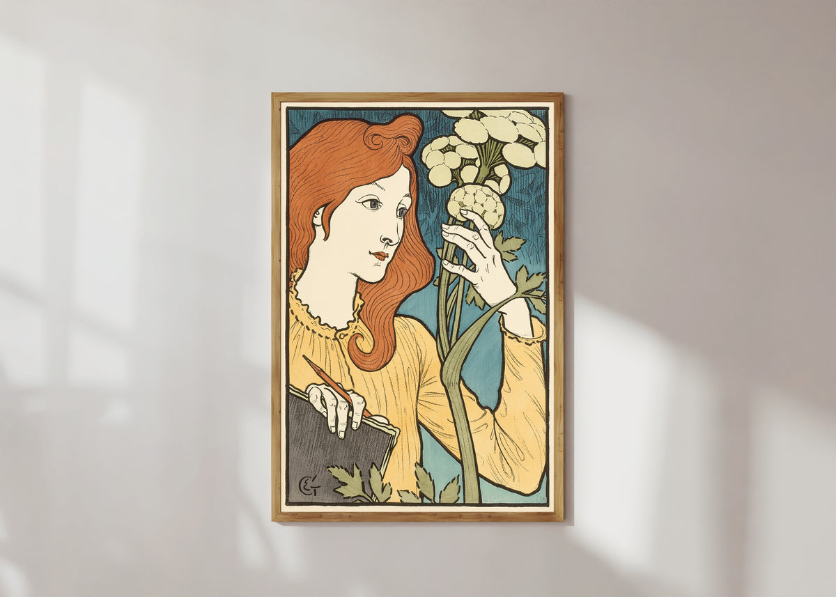 Framed art print of Salon des Cent by Eugène Grasset, in a light wood frame on a sunlit white wall