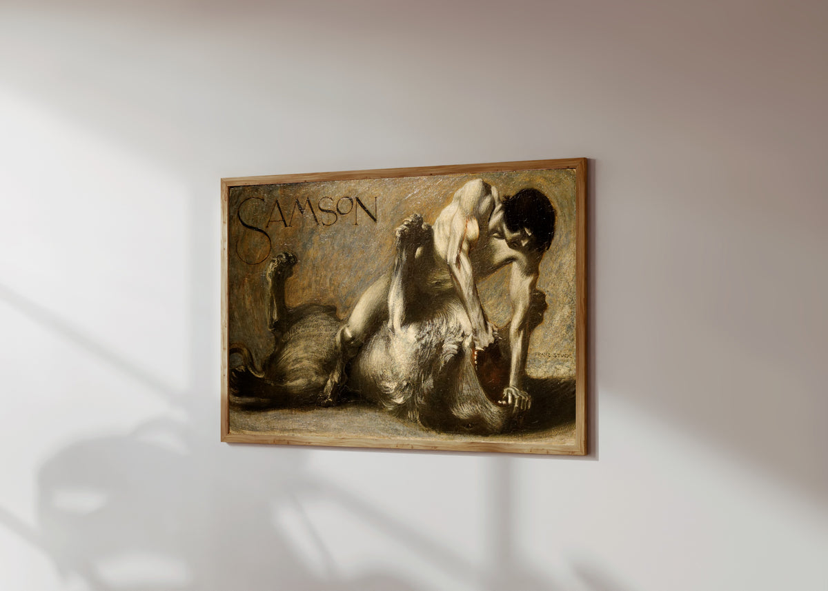 Framed art print of Samson by Franz von Stuck, in a light wood frame on a sunlit white wall, seen at a slight angle