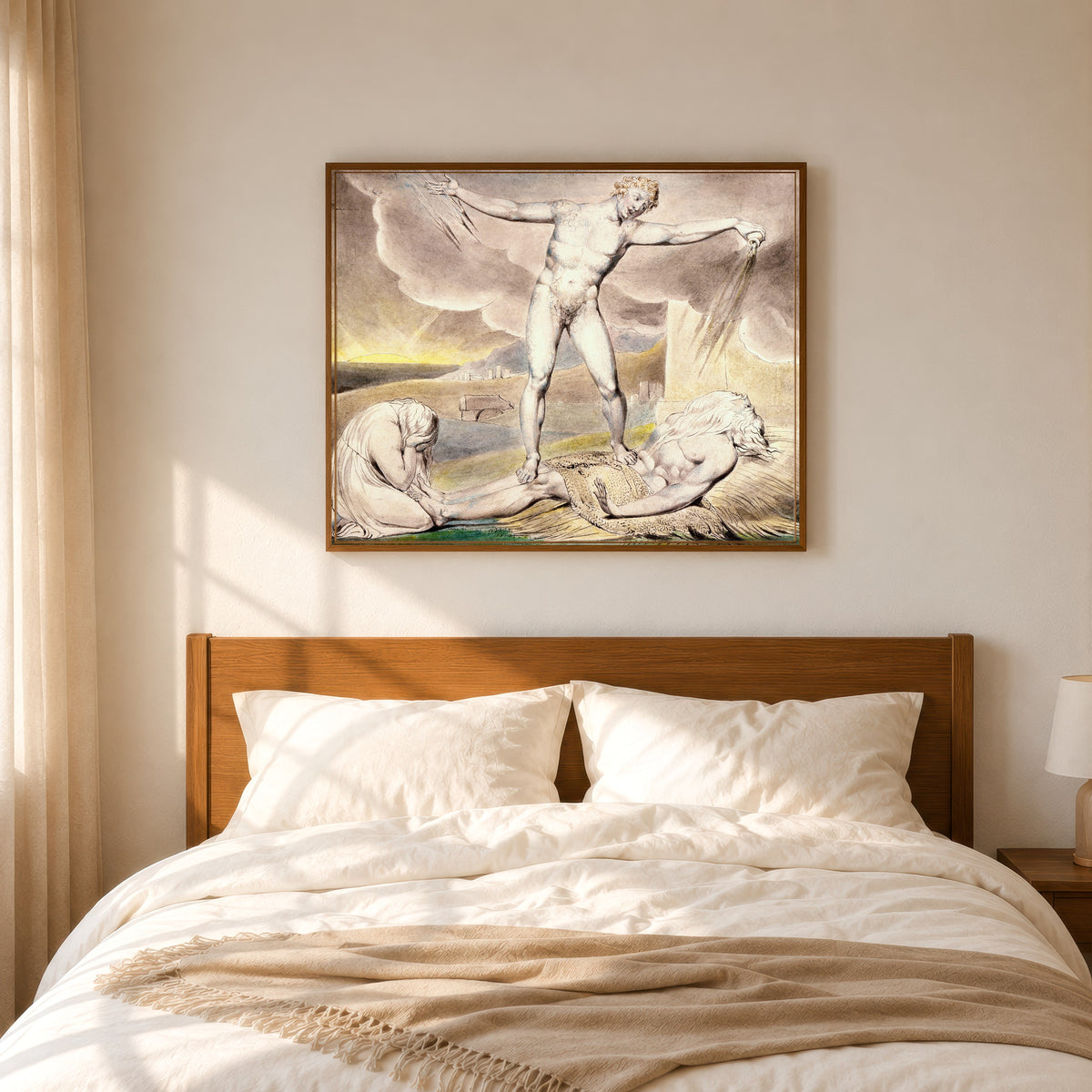 Framed art print of Satan Smiting Job with Boils by William Blake, in a slim wood frame above a bed in a sunlit bedroom