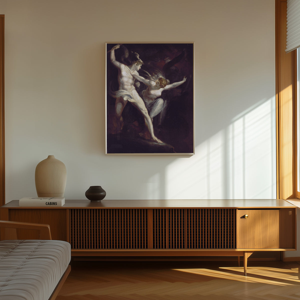 Framed art print of Satan and Death, Separated by Sin by Henry Fuseli, in a thin light frame on a sunlit wall above a wooden sideboard