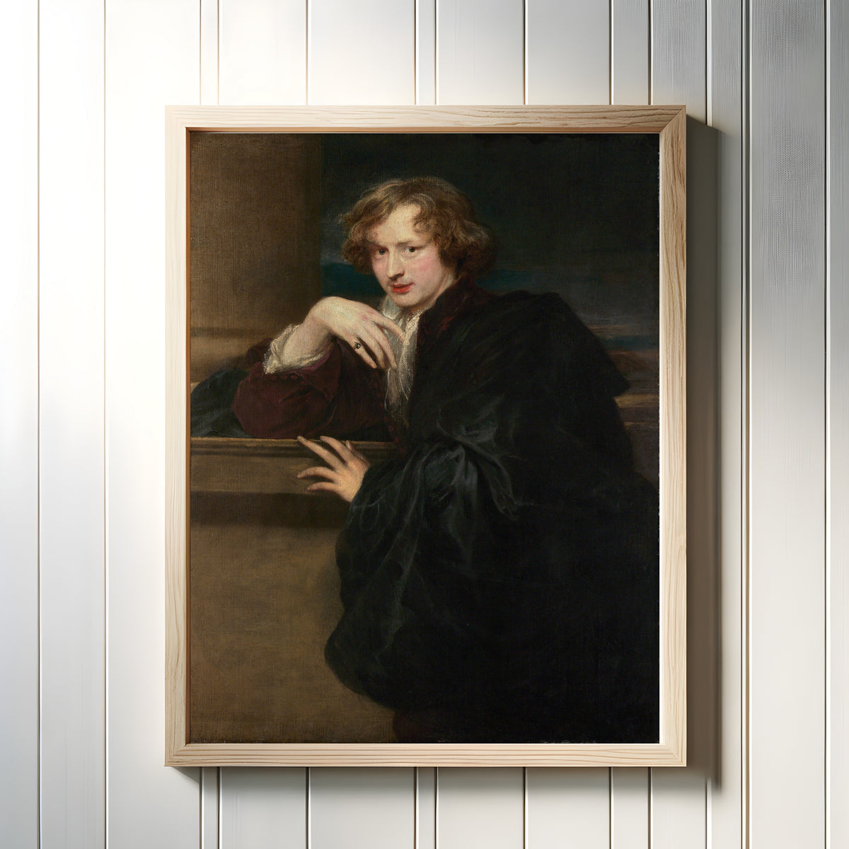 Framed art print of Self-Portrait by Anthony van Dyck, in a light wood frame on a white panelled wall