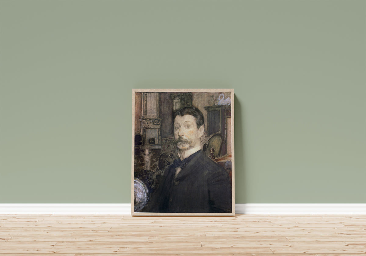 Framed art print of Self-portrait by Mikhail Vrubel, in a light wood frame leaning on a sage green wall above a wooden floor