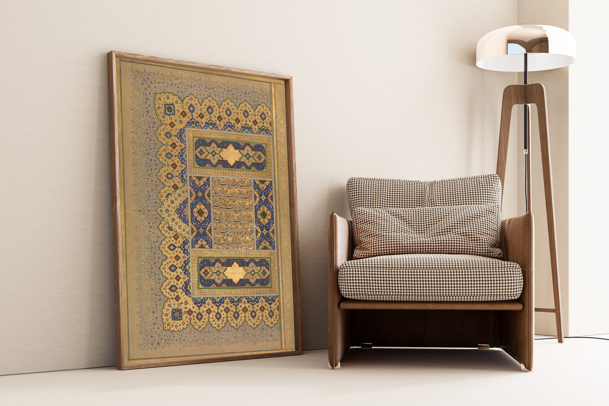 Framed art print of Shah Jahan Album: 'Unwan (Blue Floral Margin) by Mir 'Ali Haravi, leaning against a wall beside an armchair and a floor lamp