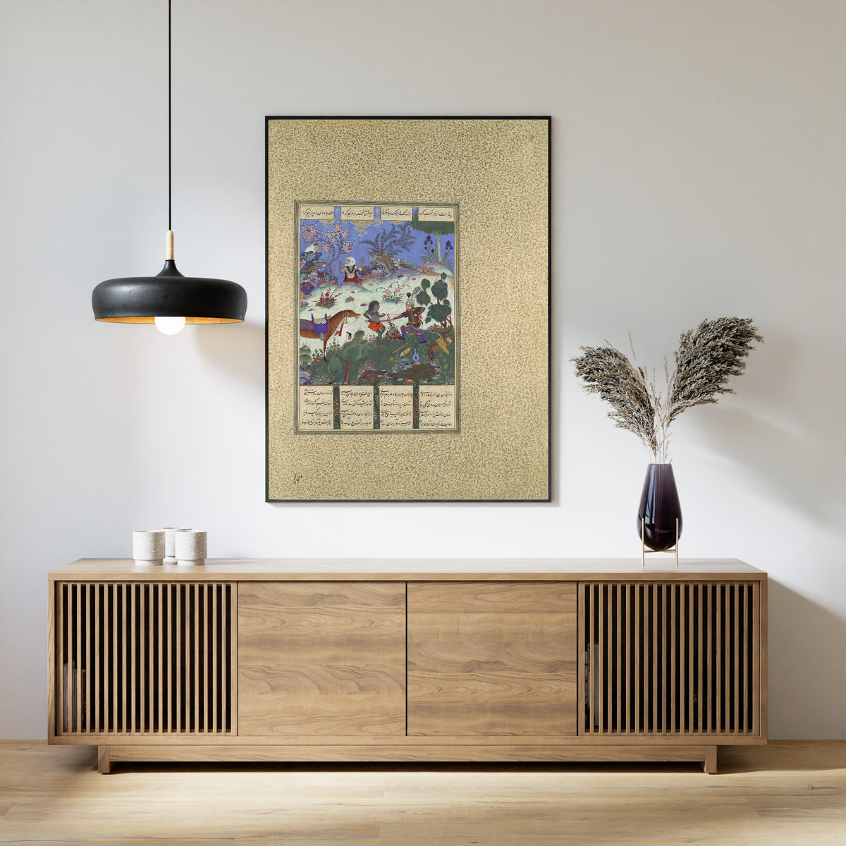 Framed art print of Shahnama of Shah Tahmasp: Rustam's Fourth Course, He Cleaves a Witch by Qadimi (attributed), above a slatted wood sideboard