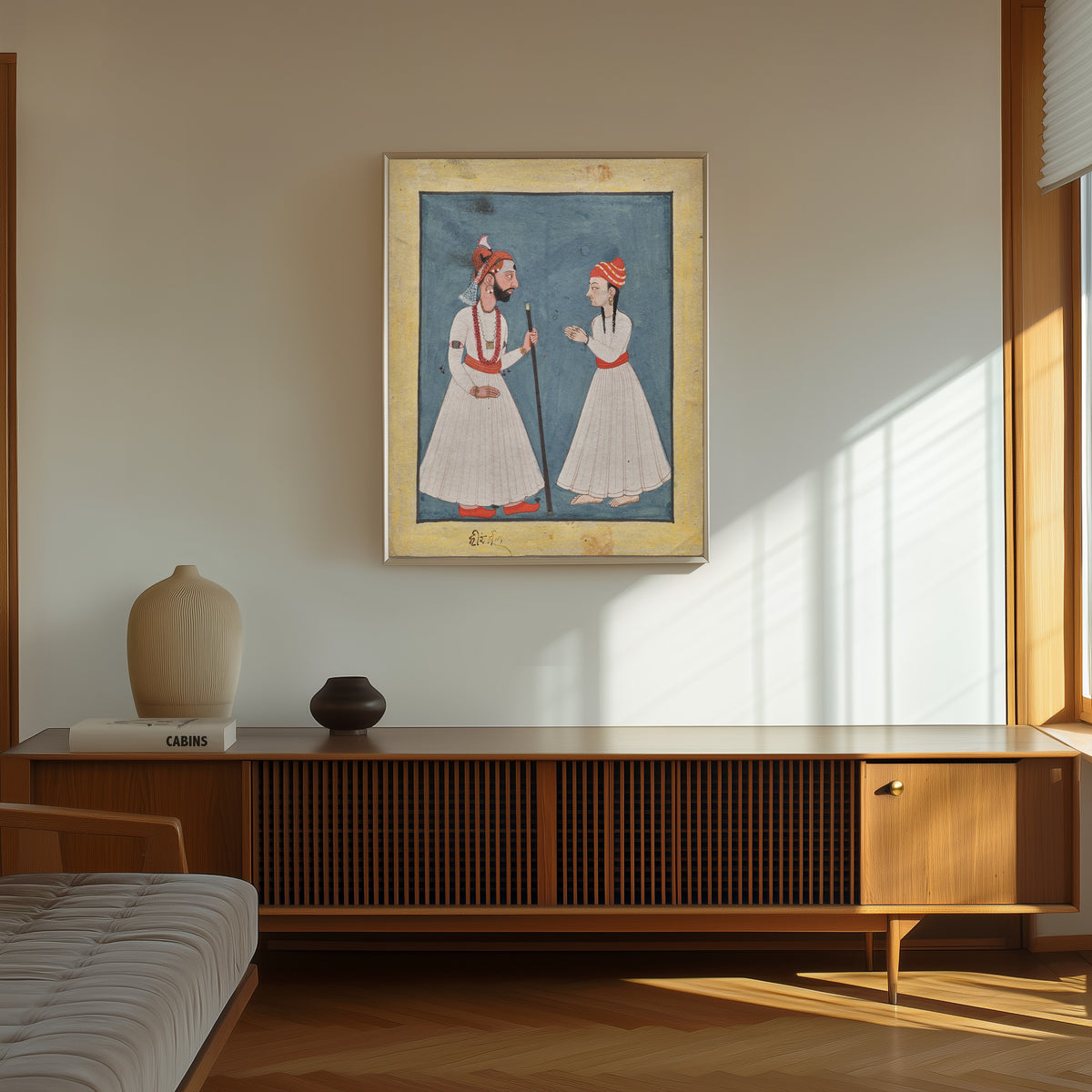 Framed art print of Shamsher Sen of Mandi with a youth by Mandi school, in a thin light frame on a sunlit wall above a wooden sideboard