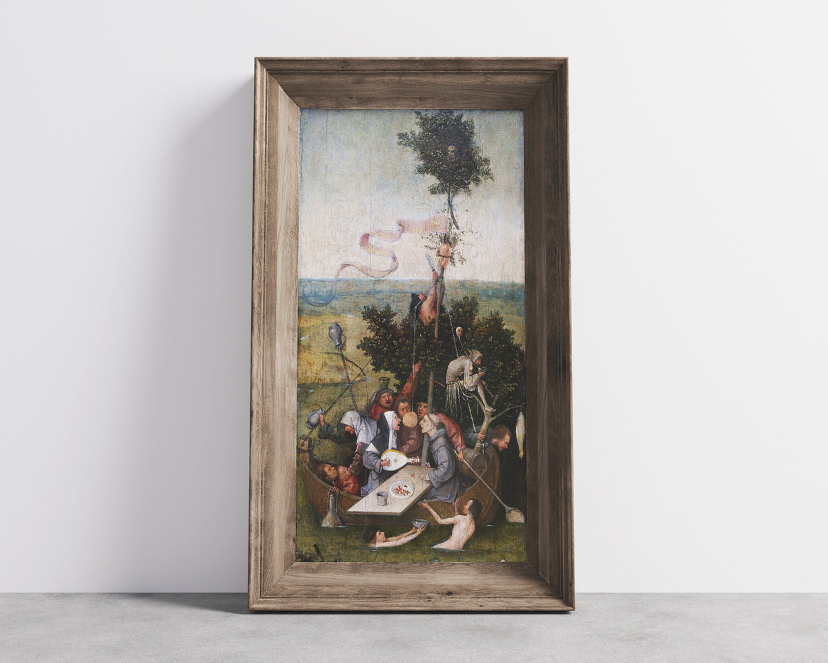 Framed art print of Ship of Fools by Hieronymus Bosch, in a wide wooden frame leaning against a concrete wall