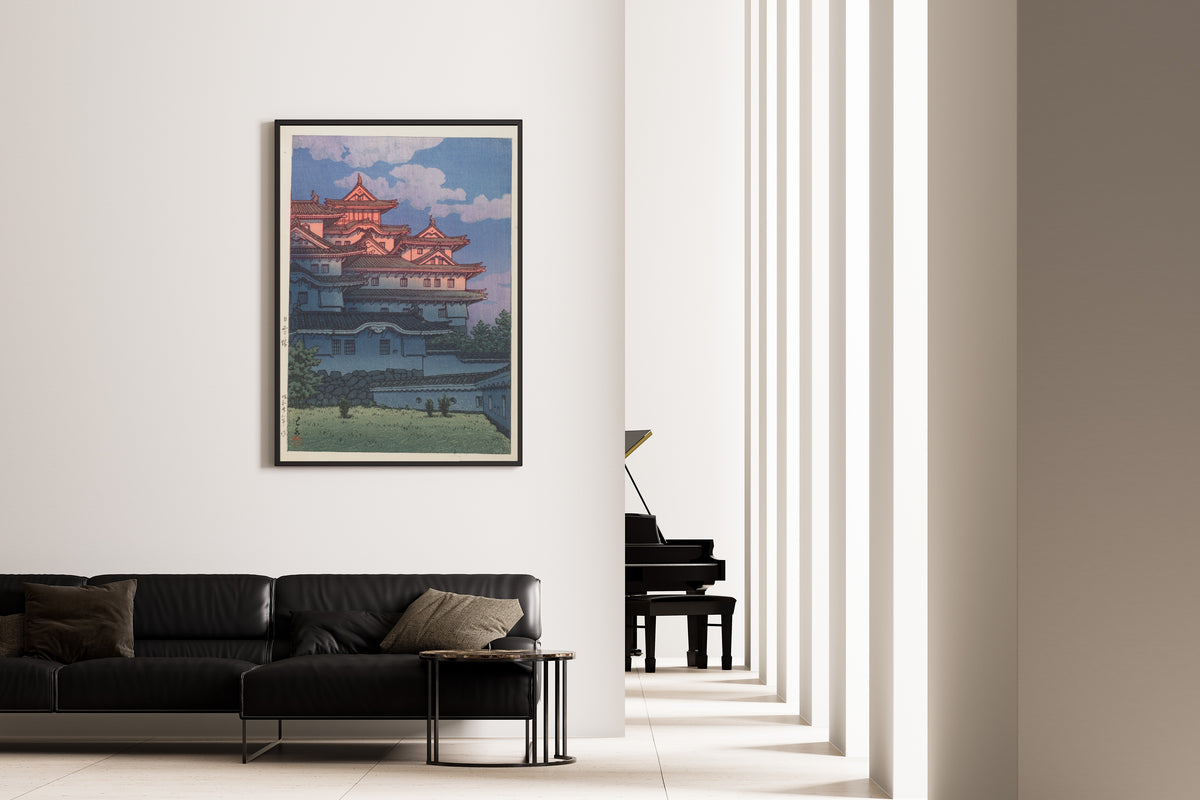 Framed art print of Shirasagi Castle by Kawase Hasui, on the wall of a minimal living room