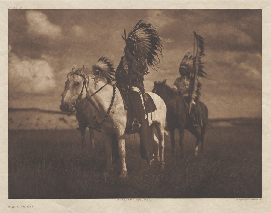 Edward S. Curtis — Sioux Chiefs | Vintage Photograph Print shown to scale on a wall above a sofa
