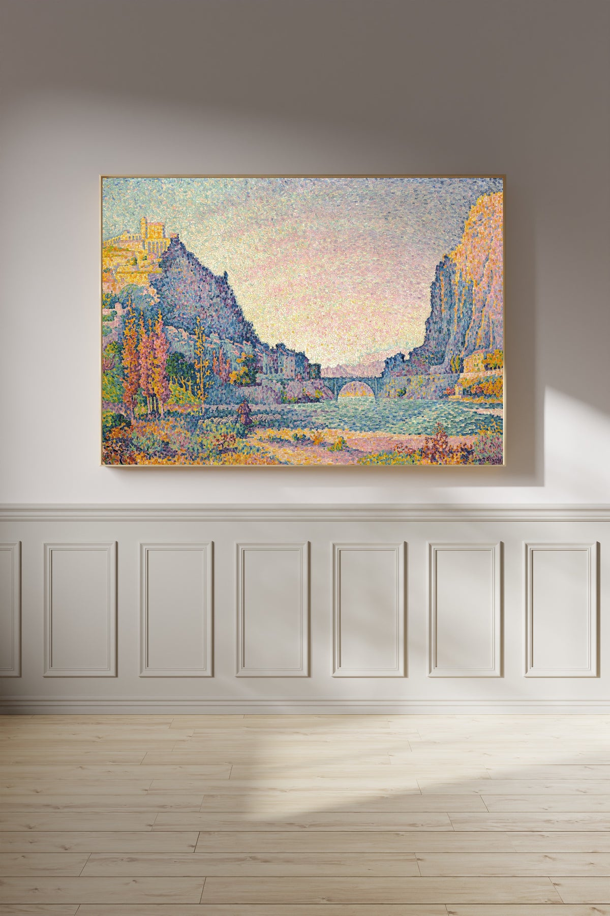 Framed art print of Sisteron by Paul Signac, on a panelled wall in afternoon light