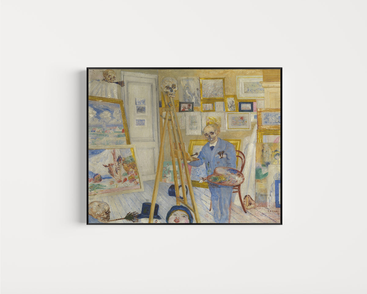 Framed art print of Skeleton Painter in His Studio (Het schilderend geraamte) by James Ensor, in a slim black frame on a plain white wall
