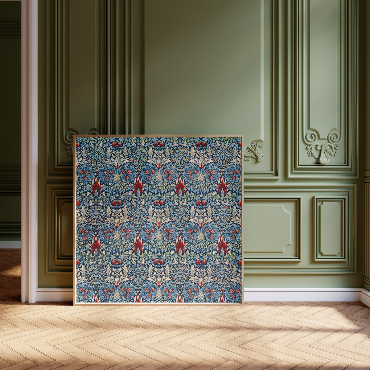 Framed art print of Snakeshead by William Morris, leaning against olive-green panelling on a herringbone floor