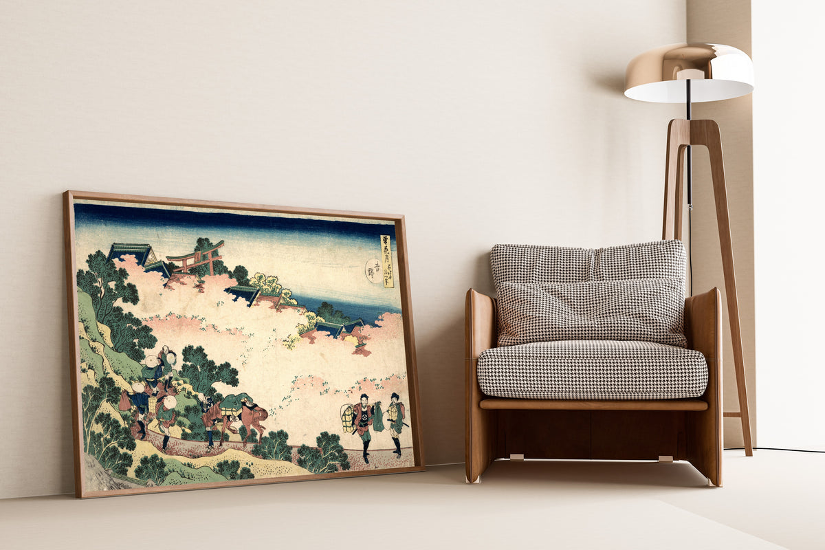 Framed art print of Snow, Moon and Flowers: Yoshino by Katsushika Hokusai, leaning against a wall beside an armchair and a floor lamp