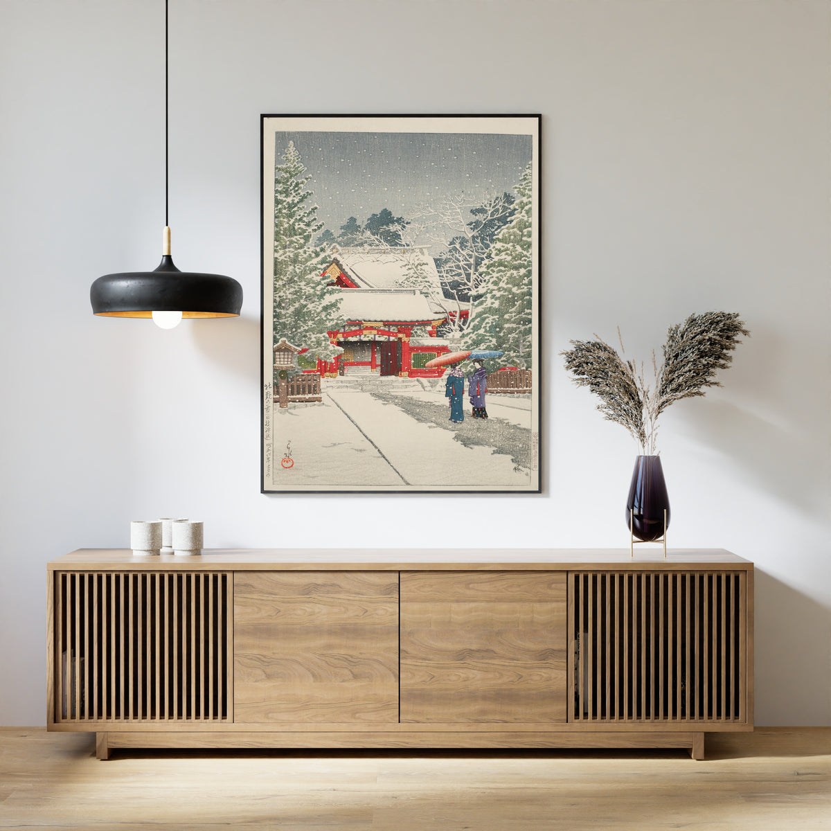 Framed art print of Snow at Hie Shrine by Kawase Hasui, above a slatted wood sideboard