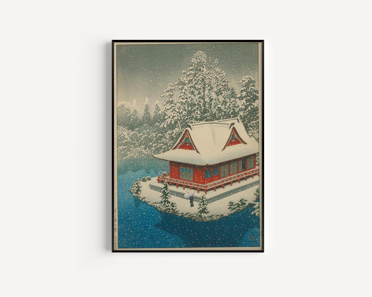 Framed art print of Snow at Inokashira by Kawase Hasui, in a slim black frame on a plain white wall