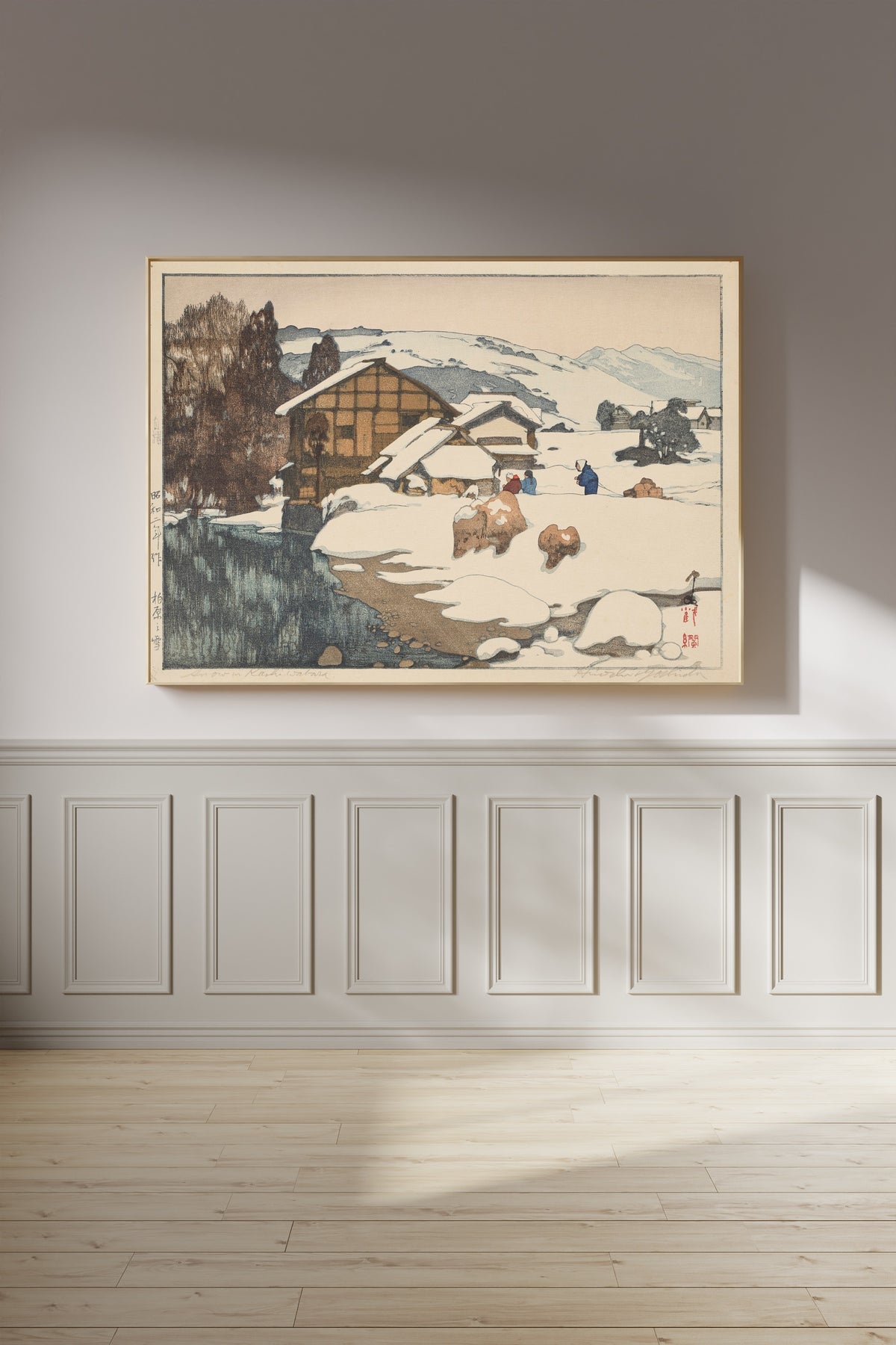 Framed art print of Snow at Kashiwabara by Hiroshi Yoshida, on a panelled wall in afternoon light
