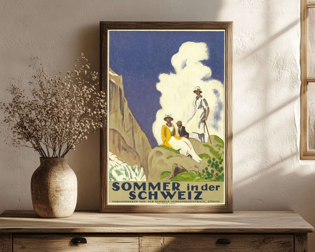 Framed art print of Sommer in der Schweiz by Emil Cardinaux, in a dark wood frame leaning on a rustic console beside dried flowers