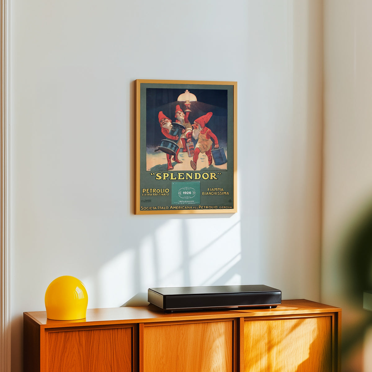 Framed art print of Splendor: Petrolio Extra Raffinato, Fiamma… by Leopoldo Metlicovitz, in a light wood frame on a white wall above an orange sideboard