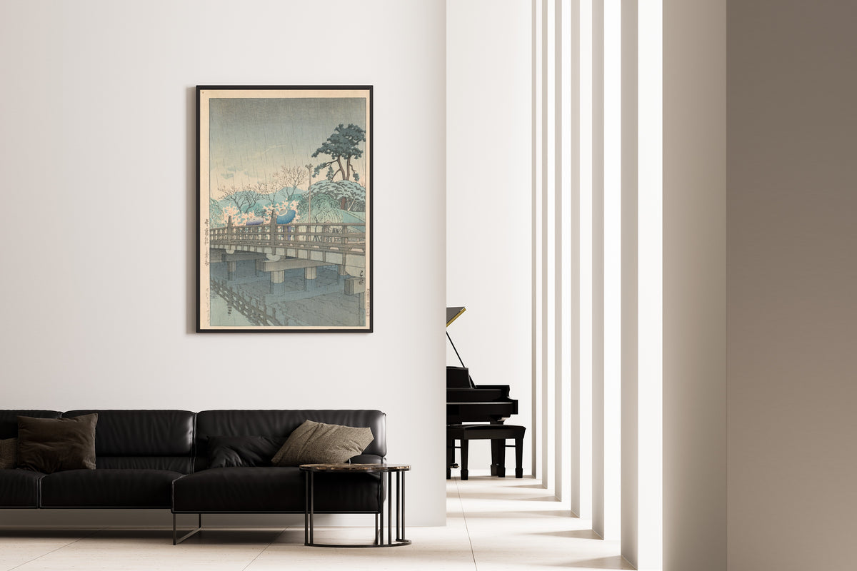 Framed art print of Spring Rain at Benkei Bridge by Kawase Hasui, on the wall of a minimal living room
